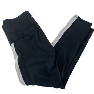 Women’s Under Armour black leggings with white stripe compression/heatgear